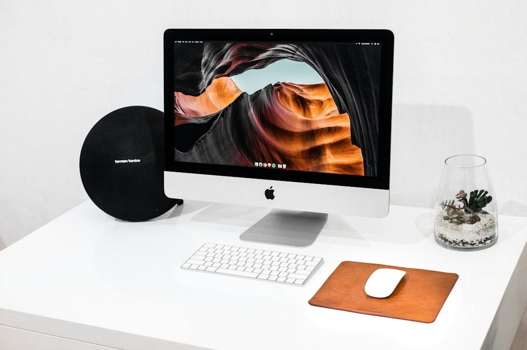 Laptop, notebook and coffee on a minimalist office desk used for trend analysis